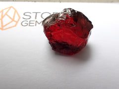 African Red Garnet. Faceting rough.  Red, very little if any brown, peachy overtones. 